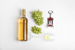 Composition With Wine And Grape On White Background, Top View