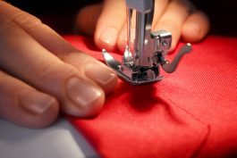 Woman,Sewing,On,Machine,,Closeup