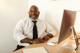man in an office smiling