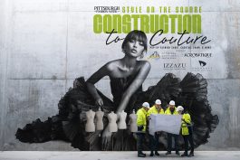 A group of engineers standing against concrete wall on construction site.